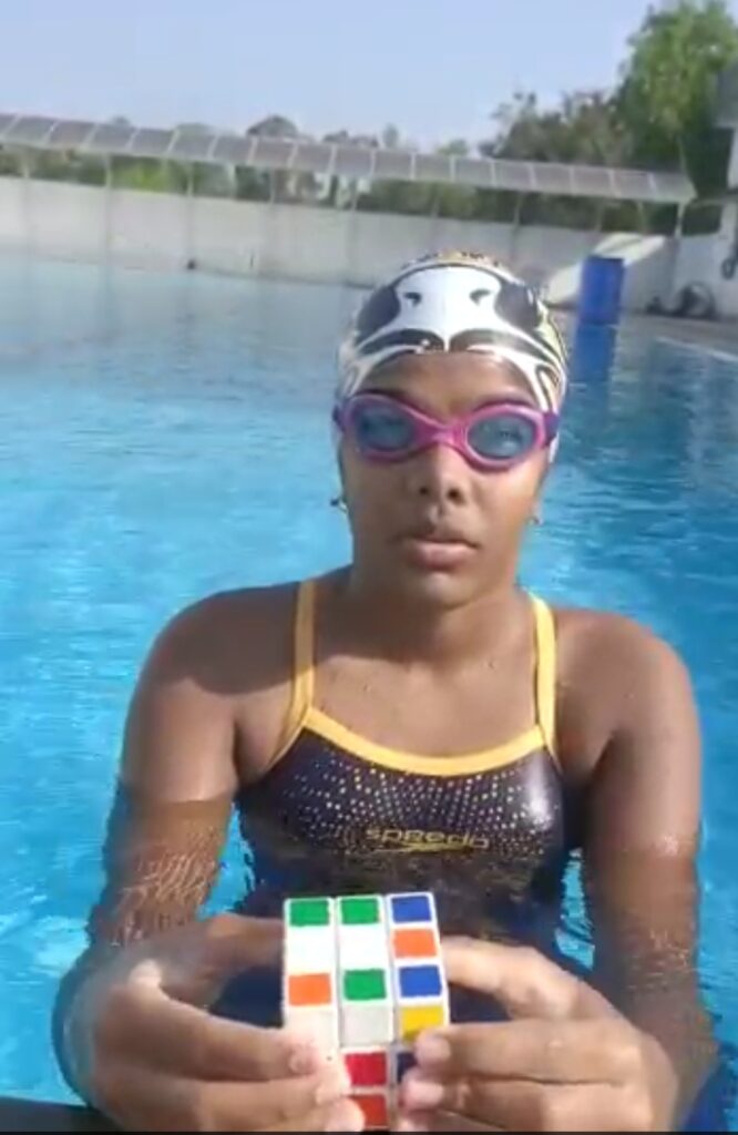 YOUNGEST GIRL TO SOLVES 12 DIFFERENT RUBIK’S CUBES WHILE SWIMMING IN THE SEA